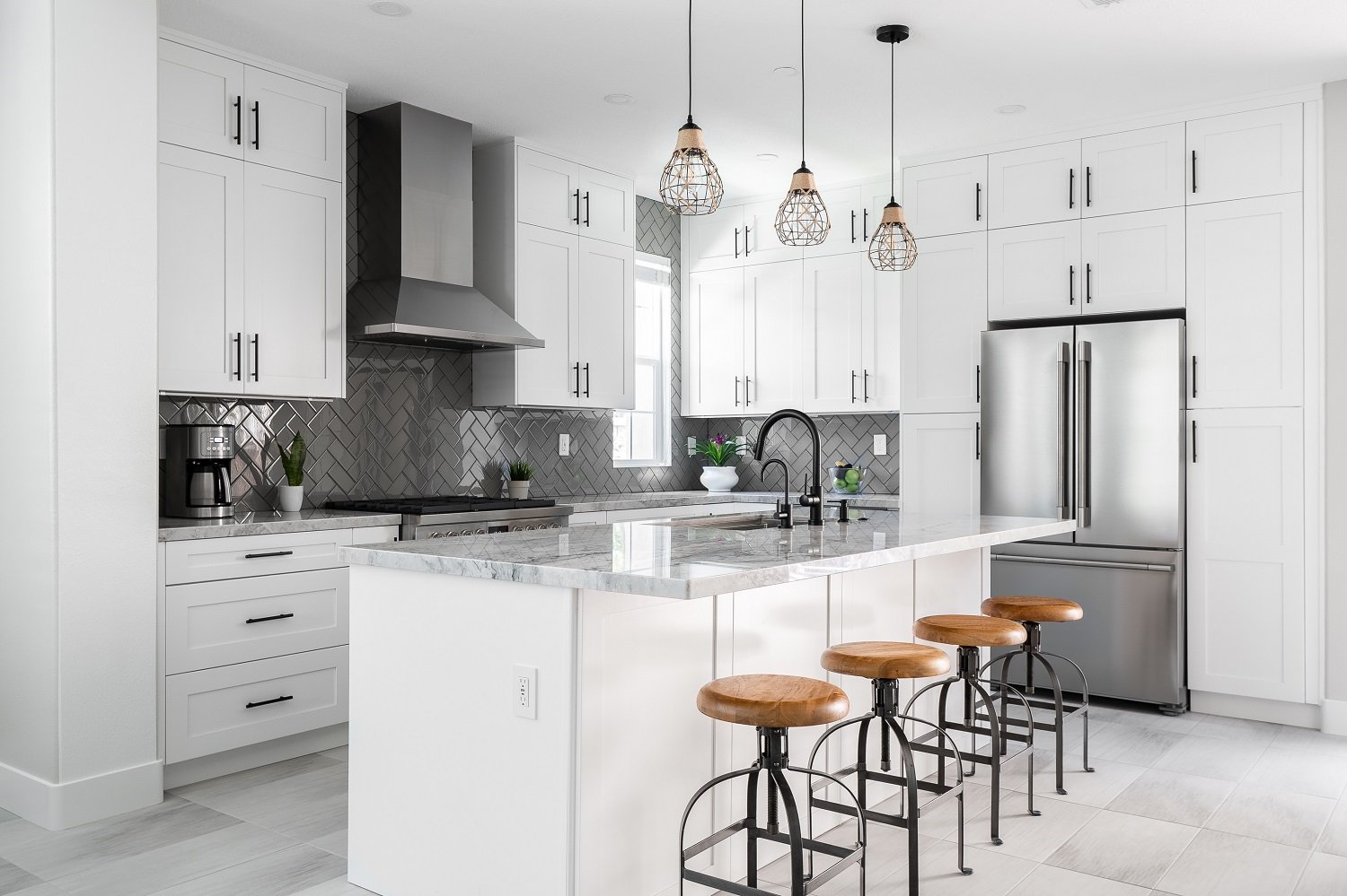 Modern kitchen with white cabinets and grey backsplash